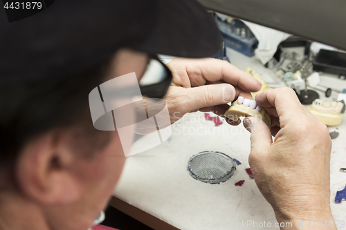 Image of Dental Technician Working On 3D Printed Mold For Tooth Implants