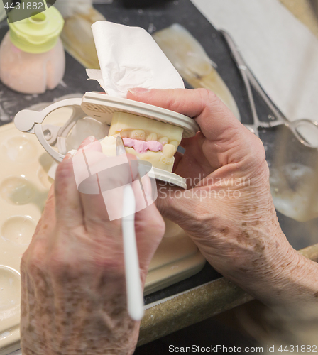 Image of Dental Technician Applying Porcelain To 3D Printed Implant Mold