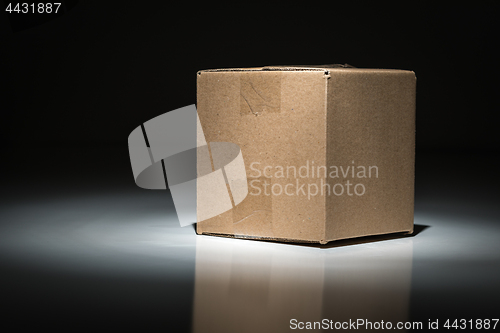 Image of Blank Carboard Shipping Box Under Spot Light.