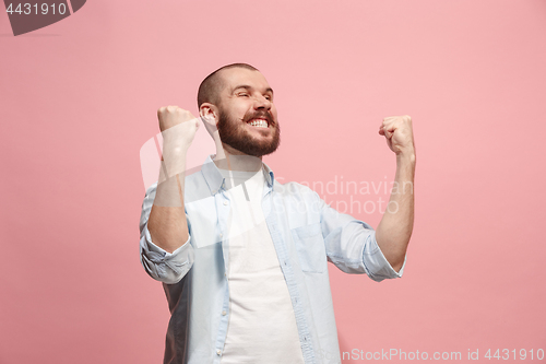 Image of Winning success man happy ecstatic celebrating being a winner. Dynamic energetic image of male model