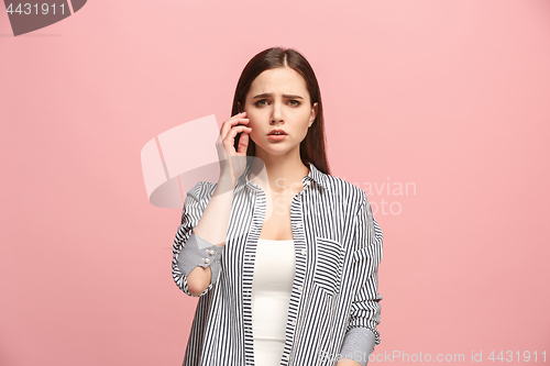 Image of Let me think. Doubtful pensive woman with thoughtful expression making choice against pink background