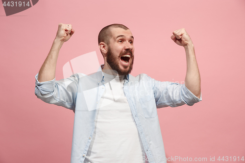 Image of Winning success man happy ecstatic celebrating being a winner. Dynamic energetic image of male model