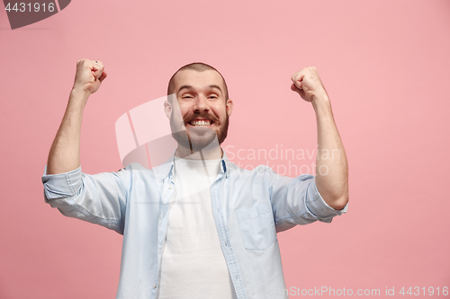 Image of Winning success man happy ecstatic celebrating being a winner. Dynamic energetic image of male model