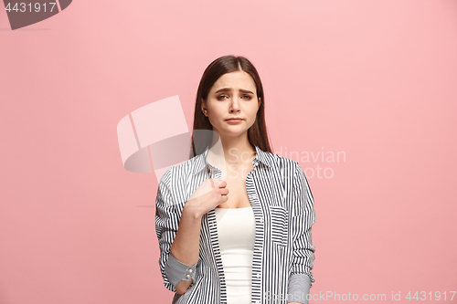 Image of Beautiful woman looking suprised and bewildered isolated on pink