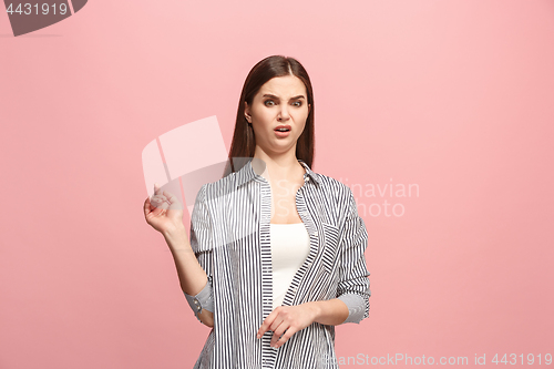 Image of Young woman with disgusted expression repulsing something, isolated on the pink