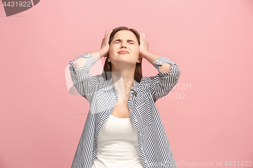 Image of Woman having headache. Isolated over pastel background.