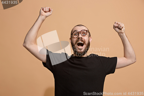 Image of Winning success man happy ecstatic celebrating being a winner. Dynamic energetic image of male model