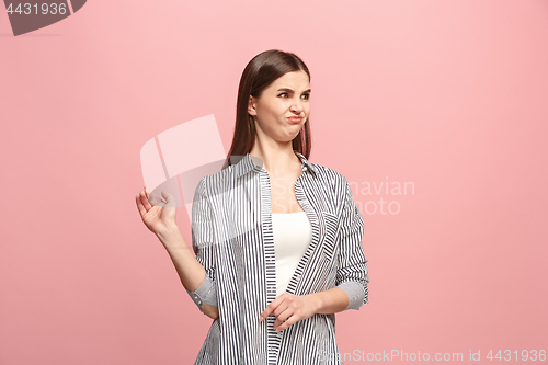 Image of Young woman with disgusted expression repulsing something, isolated on the pink