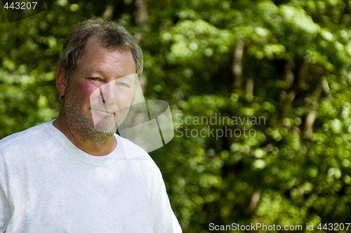 Image of happy middle age man wooded background