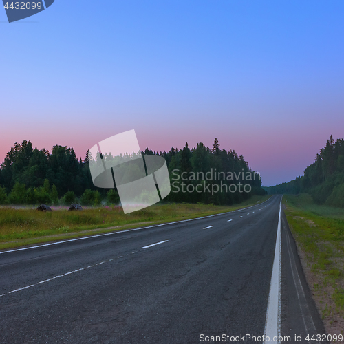 Image of Empty Straight Asphalt Road At Dusk On A Misty Morning 