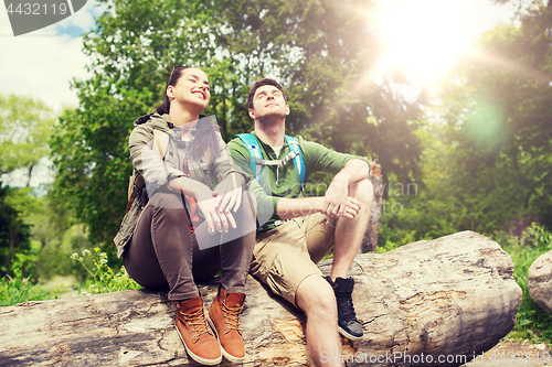 Image of smiling couple with backpacks in nature