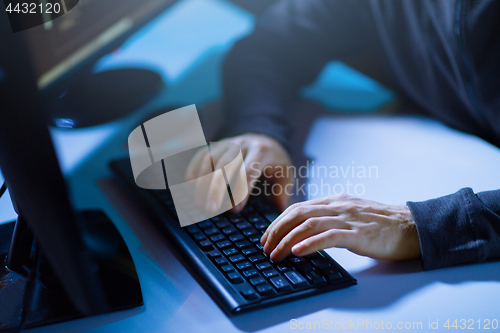 Image of hacker hands typing on computer keyboard