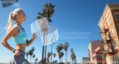 Image of woman with fitness tracker running