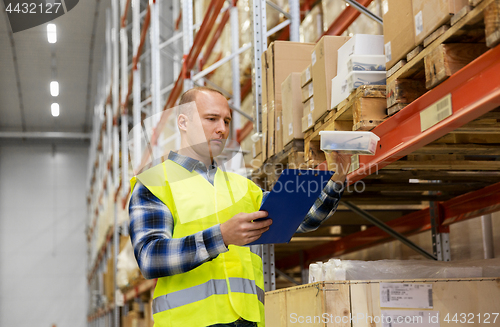 Image of warehouse worker with clipboard and plastic box