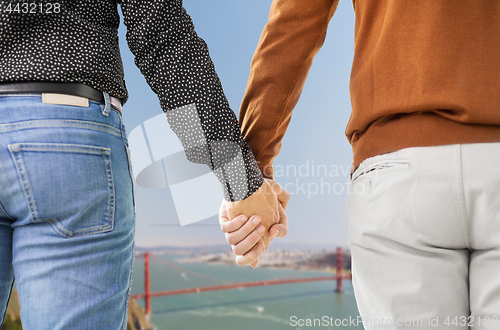 Image of close up of male gay couple holding hands