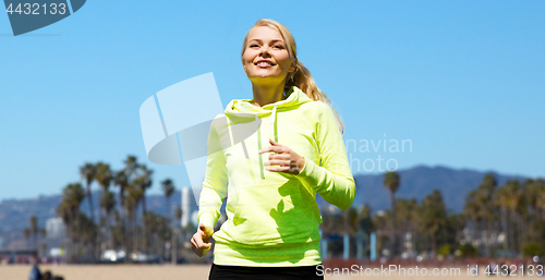 Image of woman running over venice beach