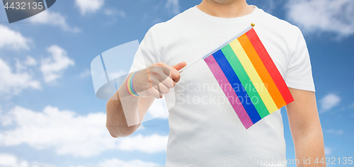 Image of man with gay pride rainbow flag and wristband