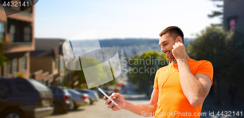 Image of man with smartphone and earphones in san francisco