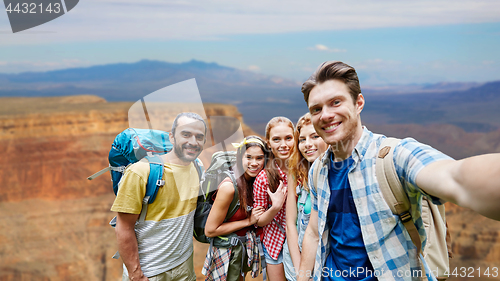 Image of happy travelers taking selfie at grand canyon