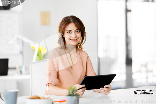 Image of businesswoman with tablet pc working at office