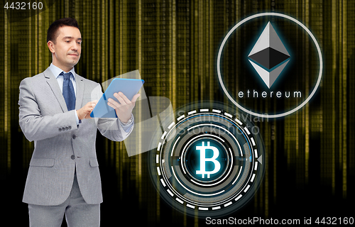 Image of businessman with tablet pc and cryptocurrency