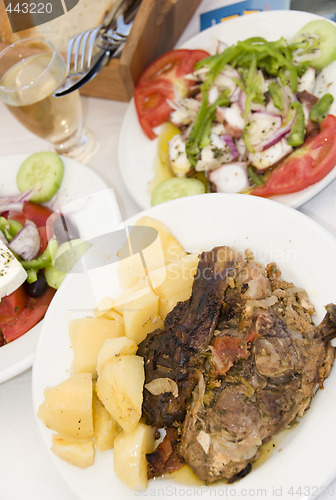 Image of lamb in the paper greek island taverna food