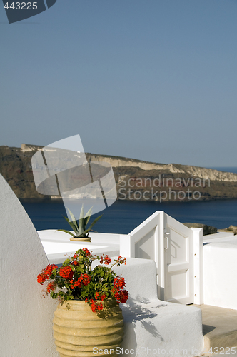 Image of house hotel with plant over sea santorini