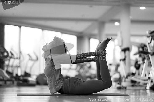 Image of african american woman exercise yoga in gym