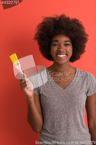 Image of black woman painting wall