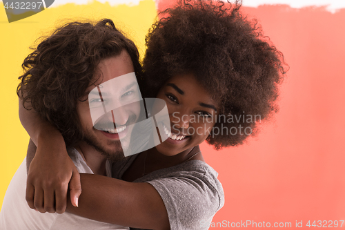 Image of Young happy multiethnic couple hugging