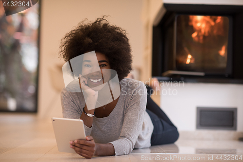 Image of black women using tablet computer on the floor