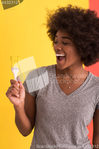 Image of black woman painting wall