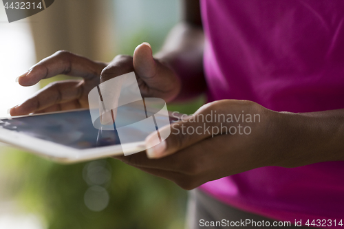 Image of african american woman using tablet