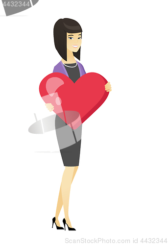 Image of Asian business woman holding a big red heart.