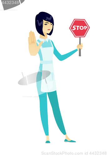 Image of Asian cleaner holding stop road sign.