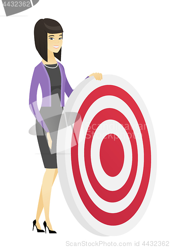 Image of Young business woman and dart board.