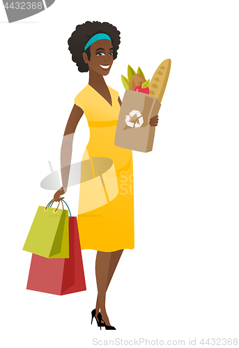 Image of Pregnant woman holding paper bag full of food.