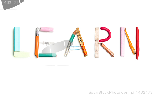 Image of The word learn created from office stationery.