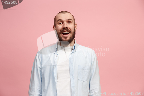 Image of The happy business man standing and smiling against pink background.