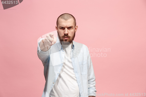 Image of The overbearing businessman point you and want you, half length closeup portrait on pink background.