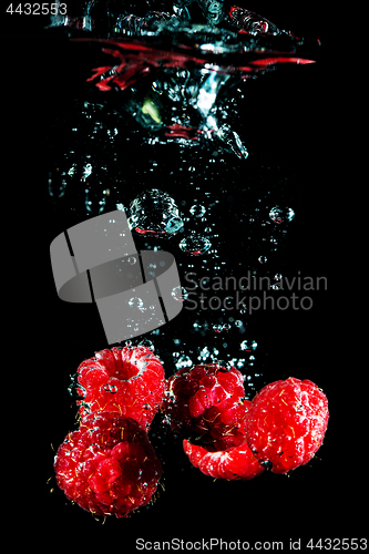 Image of Fresh berry falling in water