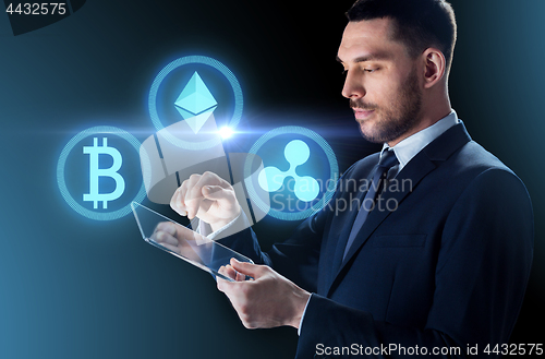 Image of businessman with tablet pc and cryptocurrency