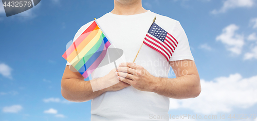 Image of man with gay pride rainbow flag and american