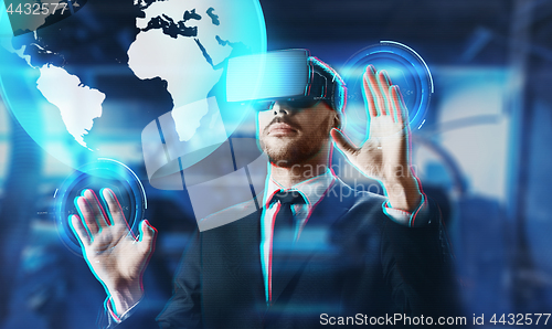 Image of businessman in virtual reality headset with earth
