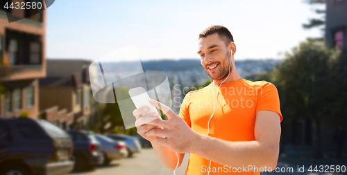 Image of man with smartphone and earphones in san francisco