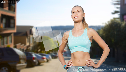 Image of happy young woman doing sports outdoors