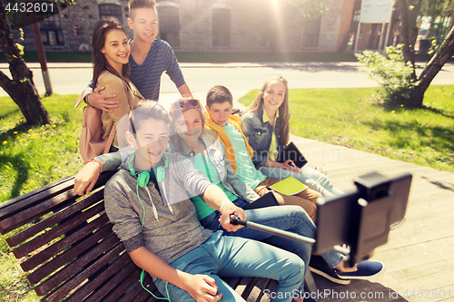 Image of happy teenage students taking selfie by smartphone