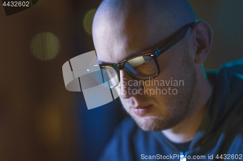 Image of close up of bald hacker in glasses 