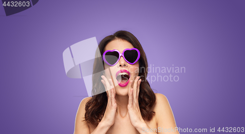 Image of woman with pink lipstick and heart shaped shades