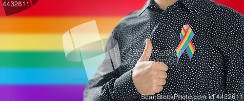 Image of man with gay pride rainbow awareness ribbon